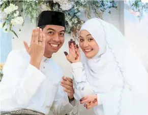  ?? ?? Partners forever: akwa and Najwa beaming in this wedding photo.