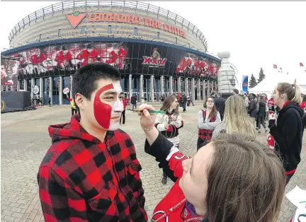  ?? WAYNE CUDDINGTON ?? Julian Scheiner has his face painted in the Red Zone in front of the Canadian Tire Centre on Wednesday evening.