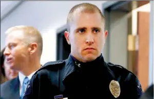 ?? AP/ED ANDRIESKI ?? Aurora police officer Justin Grizzle leaves court after testifying at a preliminar­y hearing for James Holmes at the courthouse in Centennial, Colo., on Monday. Grizzle fought to keep his composure during his testimony, in which he described wounded...