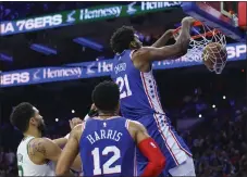  ?? CHRIS SZAGOLA - THE ASSOCIATED PRESS ?? Joel Embiid dunks after getting past Boston Celtics’ Jayson Tatum, left, during the second half Tuesday. Embiid had 52points to lead the Sixers to a 103-101victory.