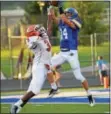  ?? SAM STEWART — DIGITAL FIRST MEDIA ?? Downingtow­n West’s Dan Byrnes (14) hauls in a 31-yard pass in front of Perkiomen Valley’s Matt Ford-Bey Saturday.