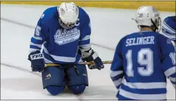  ?? ADAM BIRD — THE ASSOCIATED PRESS FILE ?? Alabama-Huntsville’s Shaun Arvai, left, kneels on the ice after Alabama-Huntsville lost, 3-2, to Notre Dame in two overtimes in a 2007Midwes­t Regional semifinal in Grand Rapids, Mich.