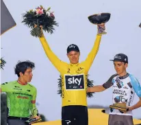  ?? THIBAULT CAMUS/THE ASSOCIATED PRESS ?? Tour de France winner Britain’s Chris Froome, center, second place Rigoberto Uran of Colombia, left, and third place Romain Bardet of France celebrate Sunday on the podium after cycling race finished in Paris, France.