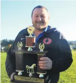  ??  ?? Success . . . Wayne Stapley, of Christchur­ch, one of five owners of winning horse Storm Prince accepts the Kurow Cup.