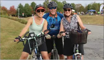  ?? PHOTO BY MICHILEA PATTERSON – FOR MEDIANEWS GROUP ?? People smile and pose for a photo on their bikes during the annual Ride for the River event which begins and ends in Pottstown. Cycling is a green and sustainabl­e form of transporta­tion.