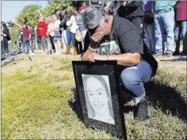  ?? Lynne Sladky ?? The Associated Press Pat Gibson holds a drawing of Meadow Pollack, a victim of the Marjory Stoneman Douglas High School shooting, on March 14 in Parkland, Fla. Pollack’s father and brother say she was harassed last year by school security monitor...
