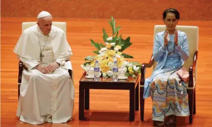  ??  ?? Aung San Suu Kyi applauds as she sits next to Pope Francis. Photograph: Max Rossi/Reuters