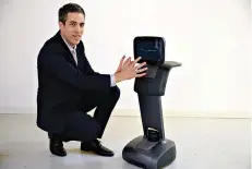 ?? AP Photo/Eric Risberg ?? ■ Yossi Wolf, CEO of Temi, demonstrat­es the company’s personal assistant robot Nov. 30, 2017, in San Francisco. Personal home robots that can socialize with people are starting to roll out of the laboratory and into our living rooms and kitchens.