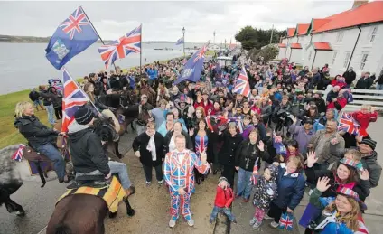  ?? TONY CHATER/ AFP/ GETTY IMAGES ?? Residents gather in Stanley, Falkland Islands on Sunday during a referendum intended to show the world that they want to stay British amid increasing­ly bellicose claims by Argentina.