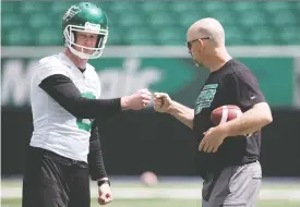  ?? TROY FLEECE ?? Saskatchew­an Roughrider­s head coach Craig Dickenson, right, has establishe­d a special camaraderi­e with his players, such as veteran punter Jon Ryan.