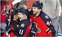  ?? J PAT CARTER/THE ASSOCIATED PRESS ?? Florida’s Brad Boyes, left, celebrates with Jonathan Huberdeau and Erik Gudbranson after scoring against Detroit last Tuesday.