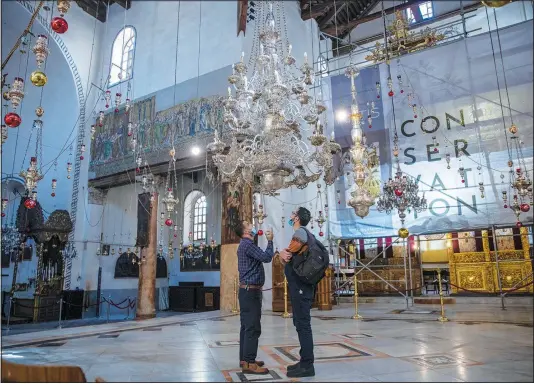  ?? (AP/Nasser Nasser) ?? Tourists visit the Church of the Nativity Nov. 16 in the West Bank city of Bethlehem.