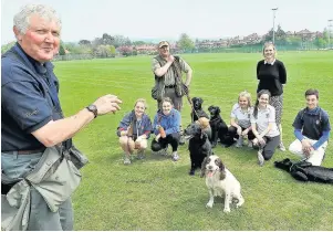  ??  ?? ●● Vet John Yarwood with Matthew Kerfoot in the centre their dogs with King’s pupils and teacher Ruth Roberts.