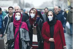  ?? (Nazanin Tabatabaee/Reuters) ?? IRANIAN WOMEN wear protective masks amid coronaviru­s fears at Tehran’s Grand Bazaar on Thursday.