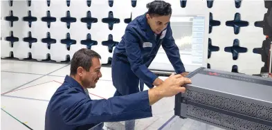  ??  ?? 5G IS A KEY AREA OF INNOVATION at Keysight. Here, technician­s install an in-house anechoic chamber used for testing 5G devices.