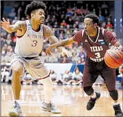  ?? AP/JOHN MINCHILLO ?? Texas Southern’s Demontrae Jefferson (right) dribbles against the defense of North Carolina Central’s Brandon Goldsmith during the Tigers’ 64-46 victory over the Eagles on Wednesday at Dayton, Ohio. Jefferson scored 25 points and grabbed eight rebounds...
