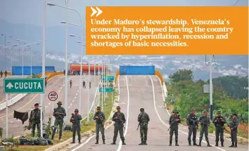  ?? AP ?? Venezuelan Bolivarian Army soldiers stand guard at the Tienditas Internatio­nal Bridge that links Colombia and Venezuela, near Urena, Venezuela on Friday.