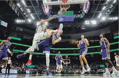  ?? MORRY GASH THE ASSOCIATED PRESS ?? Scoring’s only half the job of the offences now. Get a basket then defend, because the ball is headed back up court faster than teams can react to it, leading to more scoring.