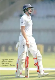  ?? — Reuters ?? England’s Joe Root walks off the field after being dismissed.