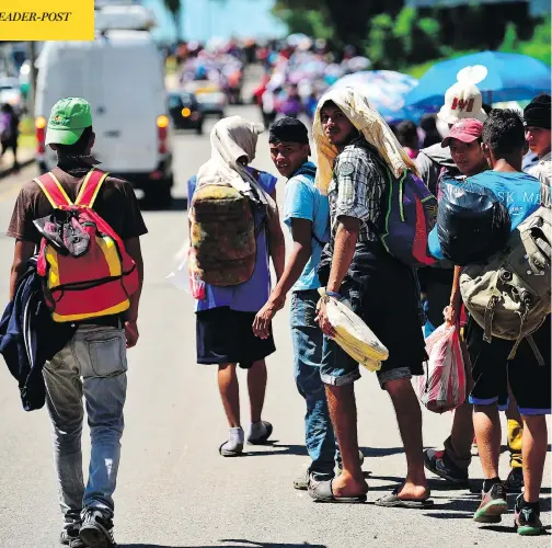  ?? PEDRO PARDO / AFP / GETTY IMAGES ?? Honduran migrants heading in a caravan to the U.S., walk alongside a road in Tapachula, Mexico on Monday.