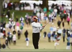  ?? Curtis Compton / Associated Press ?? Tiger Woods watches his second shot on the first hole during the third round of the Masters at Augusta National on Saturday in Augusta, Ga.