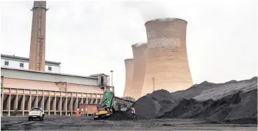  ?? PHOTO: BLOOMBERG ?? A worker supervises as a truck delivers coal supplies to the coal yard at the Grootvlei power station, operated by Eskom Holdings. All South African thermal power stations are sited on coal fields, consuming run-of-mine coal, says the writer.