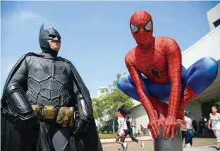  ?? Associated Press ?? Dorian Black, left, dressed as Batman, and Kyle Blankenfie­ld, dressed as Spider-Man, appear outside during Comic-Con Internatio­nal in San Diego. The annual pop-culture celebratio­n kicked off Wednesday night with a preview of the San Diego Convention...