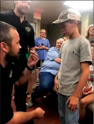  ?? Contribute­d ?? Honored: Jacob Reed, 13, was honored by David Noble and Nich Miller, EMTs with ProMed, for helping get his father out of the woods after a fall. Noble gave Jacob his ProMed Challenge Coin that he's been carrying for four years.