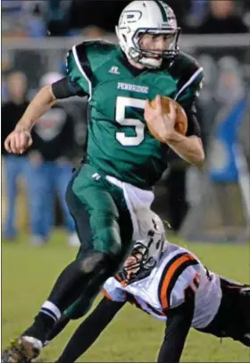  ?? For Montgomery Media / MARK C. PSORAS ?? Pennridge quaterback Alex Krivda scrambles away from Pennsbury defenders during Friday’s District One Class AAAA playoff contest at Poppy Yoder Field.