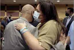  ?? AMY BETH BENNETT — SOUTH FLORIDA SUN SENTINEL VIA AP ?? Mitch Dworet and Jennifer Montalto hug during a court recess Wednesday. Dworet’s son, Nicholas Dworet, 17, and Montalto’s daughter, Gina Montalto, 14, were both killed in the massacre.