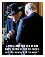  ?? ?? Camilla held the pen as her huffy hubby wiped his hands and stormed out of the room!