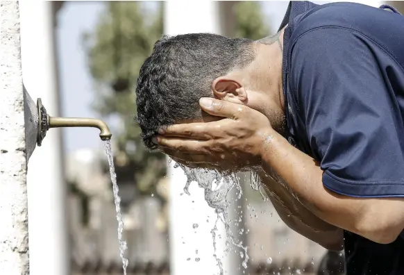  ?? AP ?? A tourists cools off in Saint Peter’s Square at the Vatican during last week’s heatwave, which was also responsibl­e for wildfires across parts of southern Europe