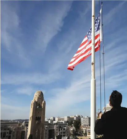  ??  ?? AN EMPLOYEE of the King David Hotel raises the US flag ahead of Vice President Mike Pence’s visit yesterday.