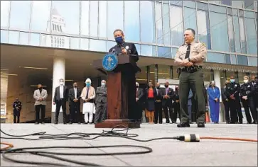  ?? Gary Coronado Los Angeles Times ?? LAPD CHIEF Michel Moore, at lectern, and L.A. County Sheriff Alex Villanueva hold a news conference last week. A federal judge on Monday placed restrictio­ns on law enforcemen­t’s use of hard-foam projectile­s.