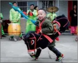  ?? ZEBING / CHINA DAILY CHEN ?? A boy performs a bamboo horse dance, designated as a significan­t cultural heritage, in Huarong county, Hunan province, on Feb 15, to celebrate Chinese New Year.