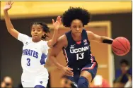  ?? Noah K. Murray / Associated Press ?? UConn’s Christyn Williams, right, drives to the basket against Seton Hall’s Lauren Park-Lane on Friday. Williams, a senior, must use her experience to help fill the void in Paige Bueckers’ absence.