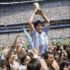  ?? ASSOCIATED PRESS ?? Diego Maradona holds up the World Cup trophy after Argentina’s 3- 2 victory over West Germany in the 1986 final match at Atzeca Stadium in Mexico City. In 2001, FIFA named Maradona one of the two greatest players in the sport’s history, alongside Pele. He was 60.