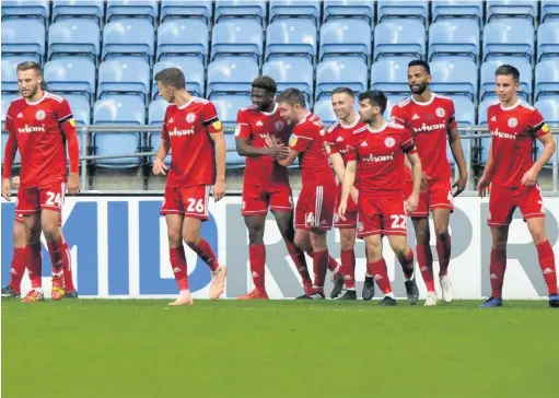  ??  ?? Offande Zanzala, centre, celebrates a goal against Coventry