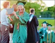  ?? SEAN D. ELLIOT/THE DAY ?? New London High School Class of 2018 graduate Cyndell Pickett celebrates with her diploma during commenceme­nt exercises Tuesday on Cannamela Field.