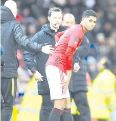  ??  ?? Rashford (centre) reacts after seeming to pick up an injury during the English FA Cup third round-replay football match between Manchester United and Wolverhamp­ton Wanderers at Old Trafford in Manchester, north west England, on January 15, 2020. - AFP photo