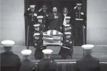  ??  ?? The casket of John Glenn is carried out of the Ohio Statehouse by Marines during his funeral procession Saturday in Columbus. The famed astronaut died Dec. 8 at age 95. John Minchillo, The Associated Press