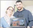  ?? MITCH MACDONALD/THE GUARDIAN ?? Sherri Spatuk and Mark Mahar, of M4G Alternativ­e Housing, show a picture of their 382 square foot tiny home following a presentati­on at Georgetown Genevieve Soloman Memorial Library on Saturday.