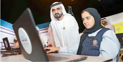 ?? Wam ?? Sheikh Mohammed with a student during the launch of Madrasa e-learning platform in Dubai on Tuesday. —