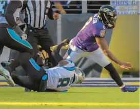  ?? KARL MERTON FERRON/BALTIMORE SUN ?? Panthers cornerback Jaycee Horn sacks Ravens quarterbac­k Lamar Jackson during the third quarter of Sunday’s game at M&T Bank Stadium.