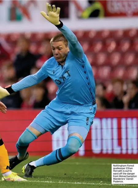  ??  ?? Nottingham Forest goalkeeper Ethan Horvath is out to ward off the danger from Wolverhamp­ton Wanderers’ Daniel Podence.