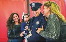  ?? AP ?? Matias Ferreira (centre) celebrates with his two-year-old daughter, his wife (left) and mother at the Suffolk County Police Department Academy graduation ceremony on Friday.