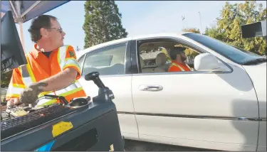  ?? NEWS-SENTINEL PHOTOGRAPH­S BY BEA AHBECK ?? Safety coordinato­r Gordon Prow and Eric Aragon, program representa­tive, test a car as the State of California Department of Consumer Affairs Bureau of Automotive Repair conducts a voluntary emissions survey on S. Ham Lane in Lodi on Wednesday.