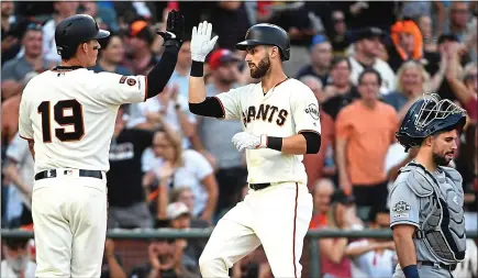  ?? DOUG DURAN — STAFF PHOTOGRAPH­ER ?? Steven Duggar, right, is greeted at home by Giants teammate Tyler Austin after hitting a home run in the fourth inning. For details on Tuesday’s game against the Padres and more on the Giants, go to MERCURYNEW­S.COM/SPORTS.