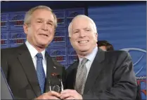  ?? PICTURE: REUTERS ?? Former president George W Bush, left, with Senator John McCain, a board member of a US website said to have been targeted by Russian hackers.