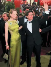  ?? CHRIS PIZZELLO — THE ASSOCIATED PRESS FILE ?? Tom Cruise and Nicole Kidman arrive for the 69th Annual Academy Awards in Los Angeles. Kidman wore an embellishe­d chartreuse Dior dress by John Galliano.